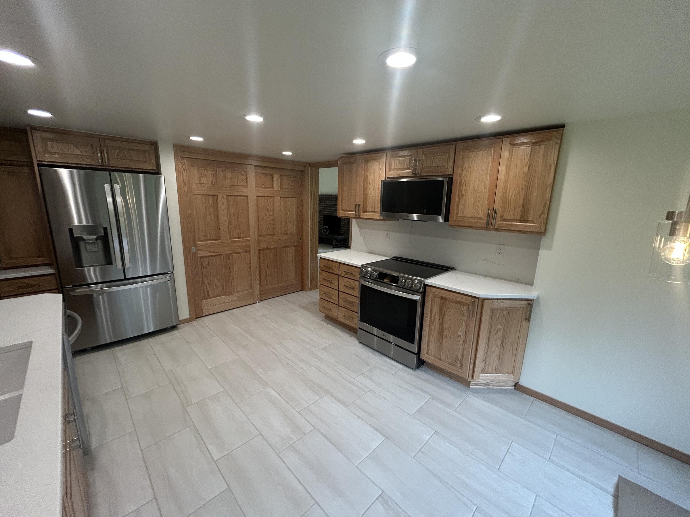 Restored kitchen with oak cabinets and stainless steel appliances