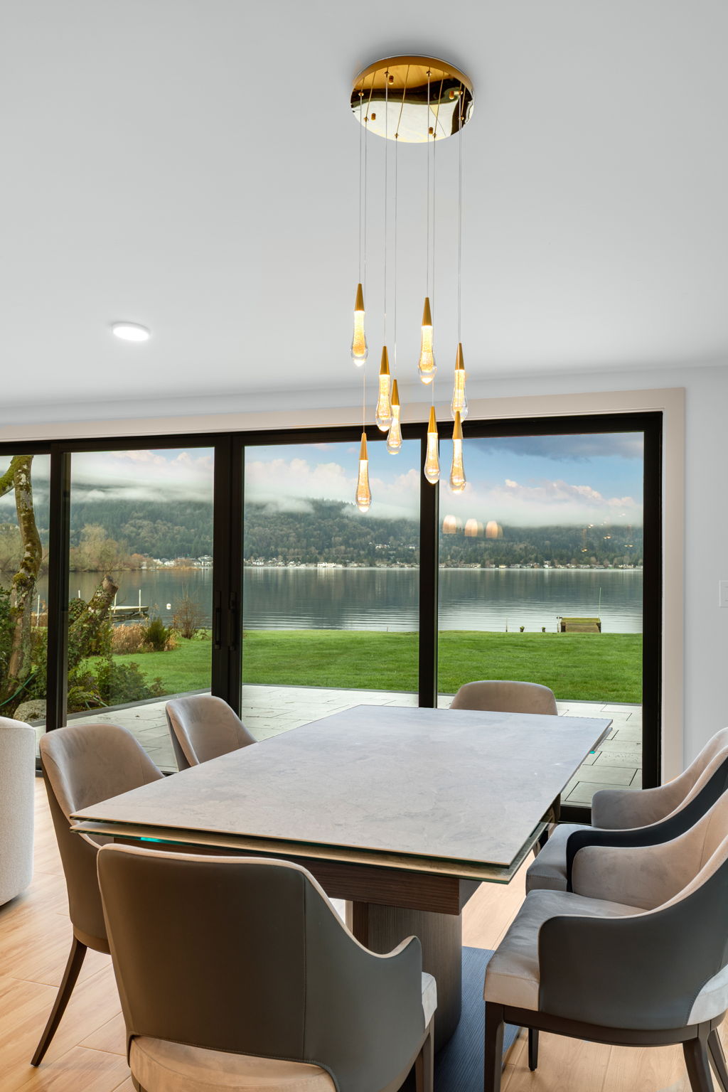Dining room with pendant lighting and lake view